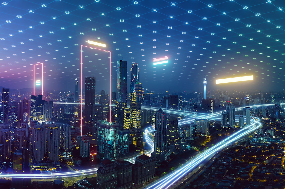 Cityscape at night with headlight beams and diamond patterns in the sky