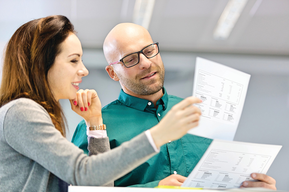 Coworkers reviewing print-outs