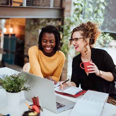 Coworkers smiling while they look at reports together