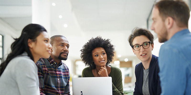 colleagues sitting around table.