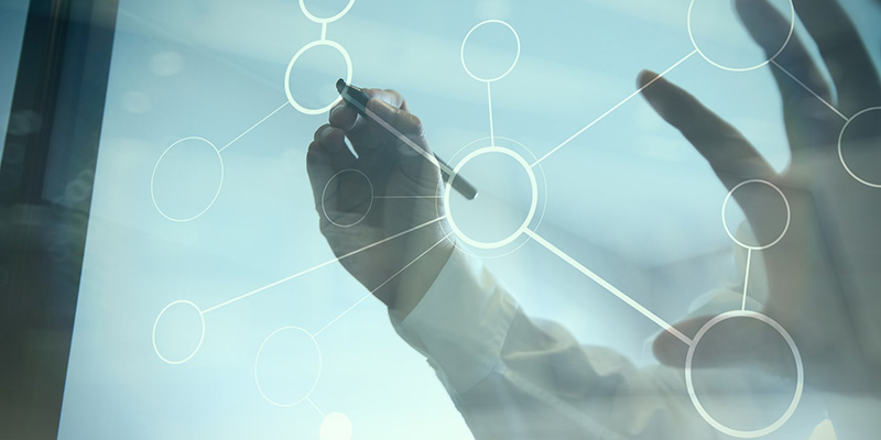 Hands writing on see-through board