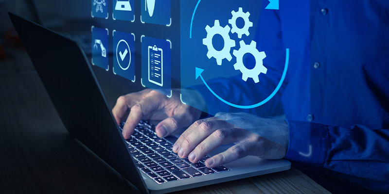 Person typing on keyboard with icons above.