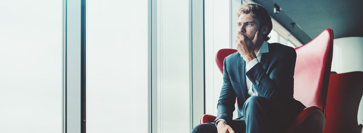 man sitting in chair thinking