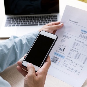 Cell phone, laptop and printed bill