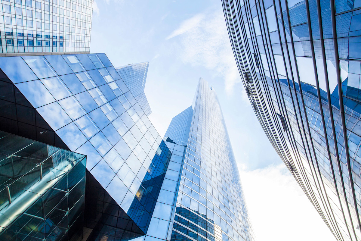 Photo of city buildings looking upward from street level