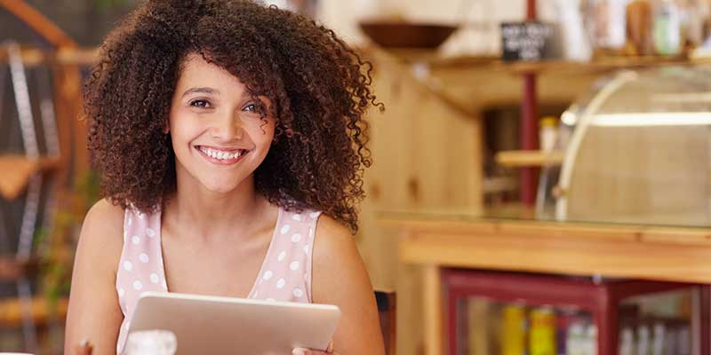Woman in coffee shop using a tablet