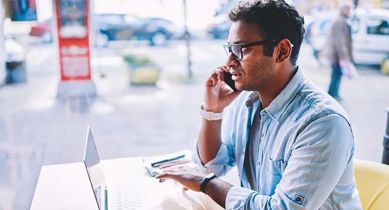 Worker in a car dealership talking on phone