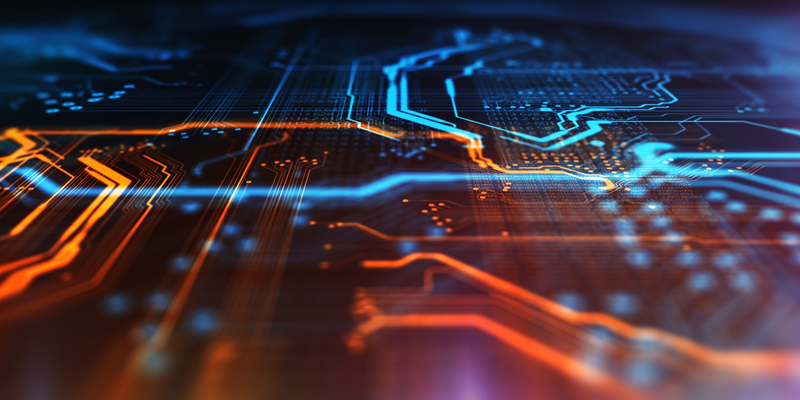 An up close image of a technology chip with blue and orange coloring.